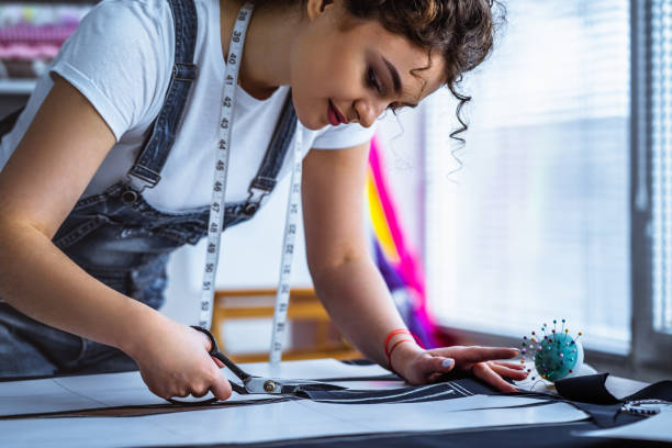 istock The beautiful tailor sews a dress on the table 1139906135