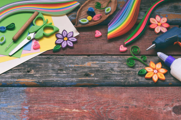 istock Quilling technique. Paper strips, flowers, scissors, elements. Handmade crafts on holiday theme: Birthday, Mother's Day, March 8, Wedding. Making decoration or greeting card. Children's DIY concept. 1139906358