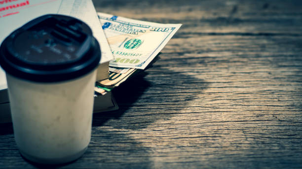 istock US dollar banknote money stack inside the book lay on old textered wooden plank, professional financial management concept. 1139907063