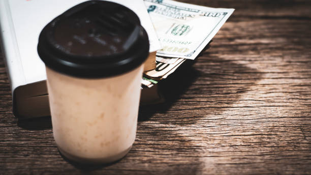 istock US dollar banknote money stack inside the book lay on old textered wooden plank, professional financial management concept. 1139907066