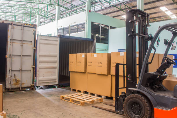 istock The forklift loading pallet with a forklift into a truck. 1139907087