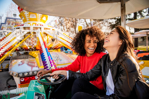 Having fun. Two friends riding amusement park ride fun ride stock pictures, royalty-free photos & images