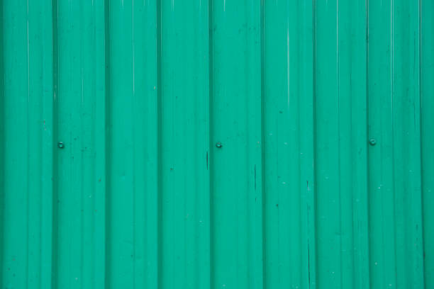 istock Green weathered metallic roll up door. Rusty iron gate. 1139908145
