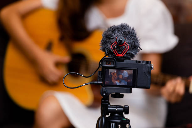 istock Young woman playing guitar for vlog 1139909118