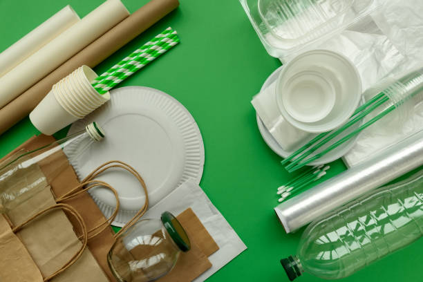 istock Plastic, paper and glass packages on green background. Copy space. Top view. Eco and save earth concept. 1139909323