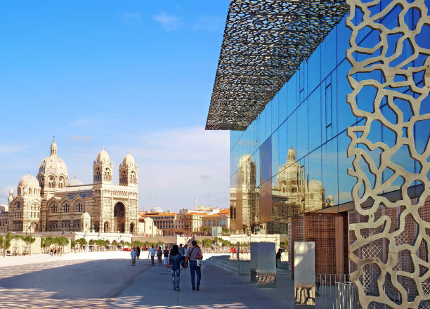 Cathedral of the Major reflecting on a facade of the Natural History Museum of Marseille.
