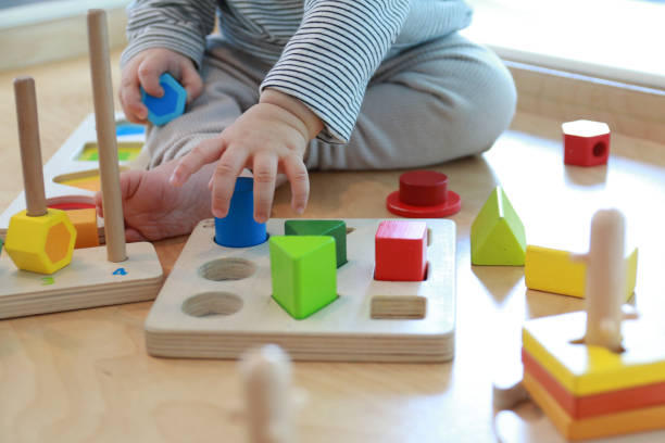 istock baby playing with wooden blocks 1139910680