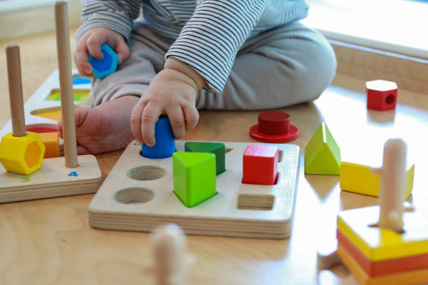 istock baby playing with wooden blocks 1139910800