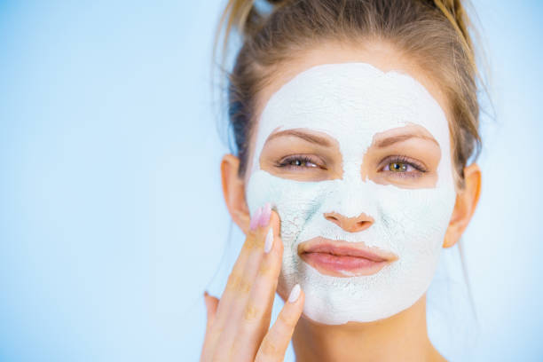 istock Girl with dry white mud mask on face 1139910947