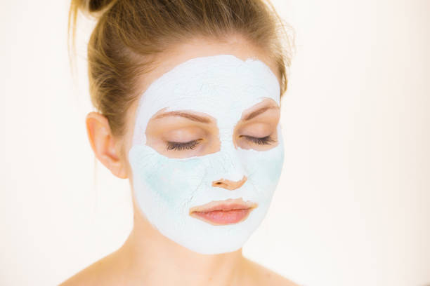 istock Girl with green mud mask on face 1139911017