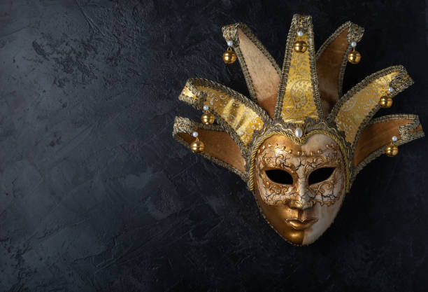istock Venetian mask on a black background. Gilded mask on a stone black wall background. 1139911376