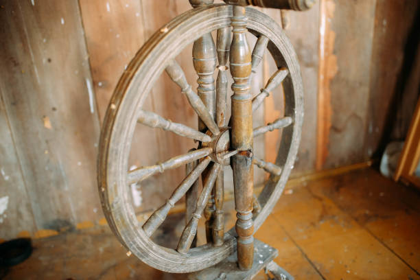 istock vintage wooden spinning wheel for yarn on a rustic boardwalk background 1139912863