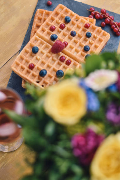 istock Waffles with fruits on wooden background 1139912936