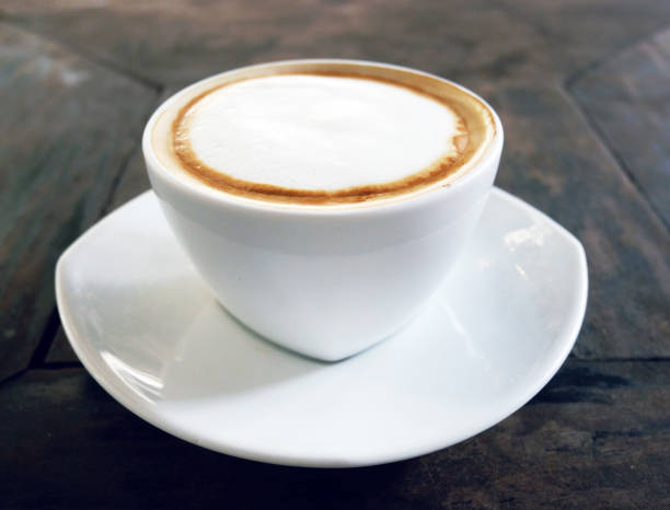 istock Close-up white coffee cup on wood table. 1139912965