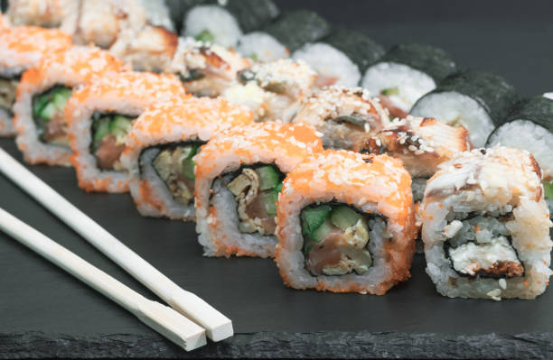 istock sushi set rolls with salmon eel cheese cucumber rice sauce sesame caviar with chopsticks 1139914061