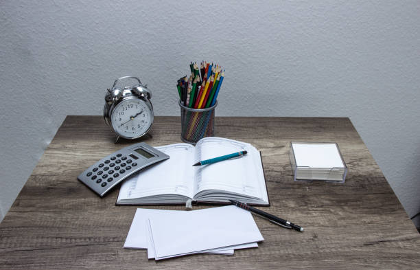 istock Time planning, daily agenda notebook on a wooden working table opened an ready for notes. Home work place/office 1139915582