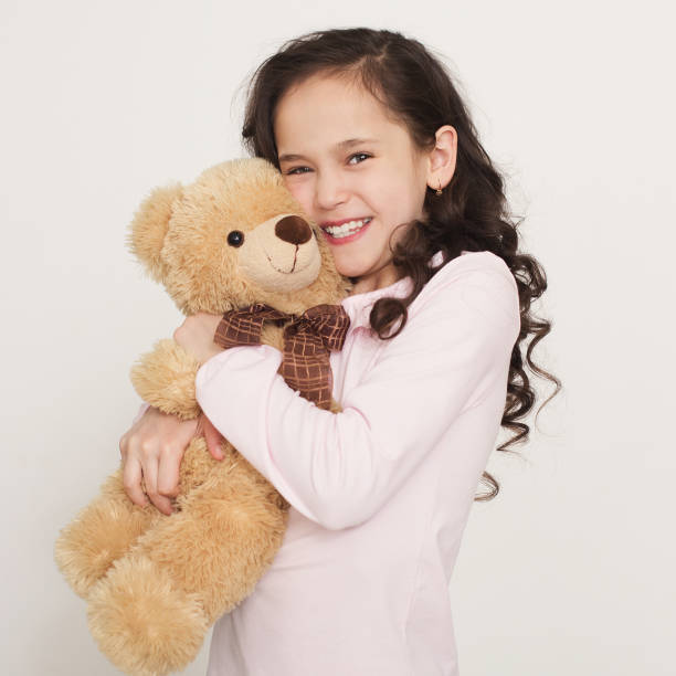 istock Cute little girl hugging teddy bear 1139917041