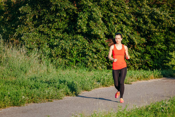 istock young woman running in park 1139917333