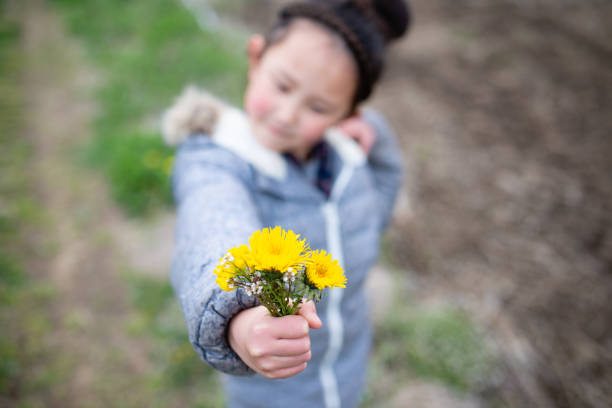 istock Girl passing a yellow flower 1139917863