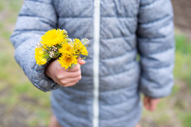 Girl passing a yellow flower