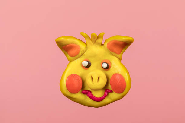 istock Head of plasticine pig on pink background 1139924058