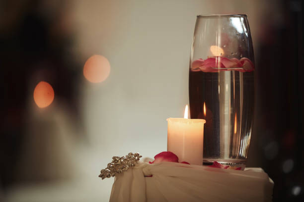 istock wedding decoration a candle and a vase with water on a white table. Flasks with water and a floating candle 1139924071