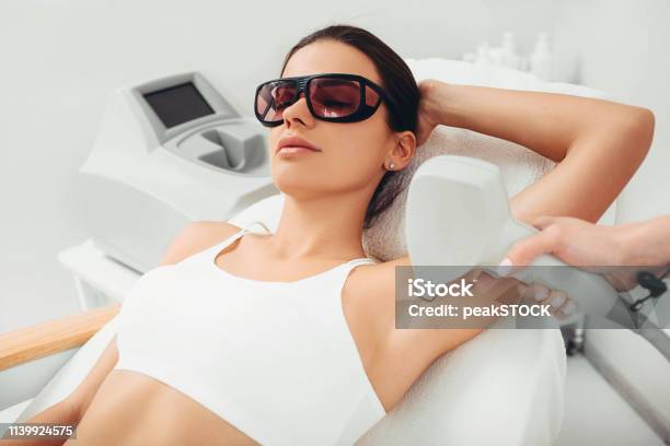 Woman Having Hair Removal Laser Epilation On Underarm Areas Hair Reduction Stock Photo - Download Image Now