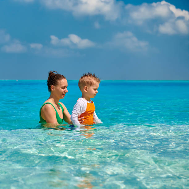istock Toddler boy on beach with mother 1139924777