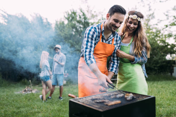 istock Beautiful woman and handsome man having barbecue 1139931067