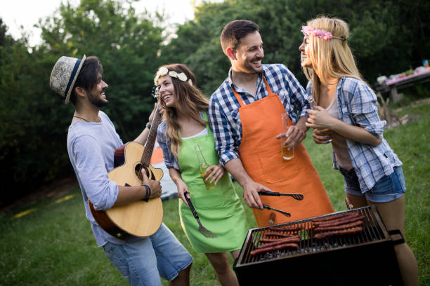 istock Group of happy people standing around grill, chatting, drinking and eating. 1139932039