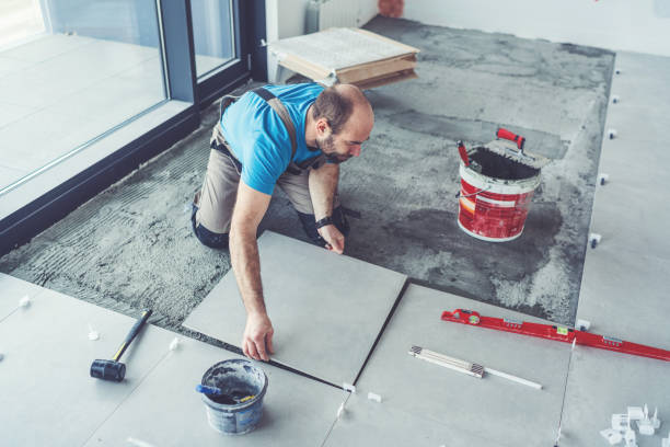 istock Tiler laying tiles on the floor 1139932147