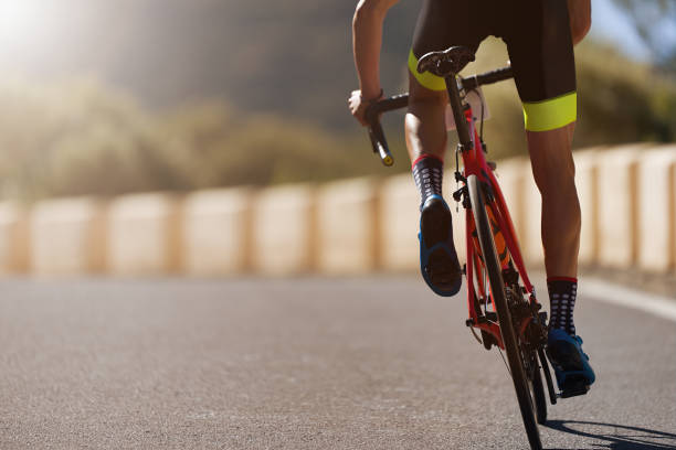 Road bike cyclist man cycling Road bike cyclist man cycling, athlete on a race cycle endurance stock pictures, royalty-free photos & images
