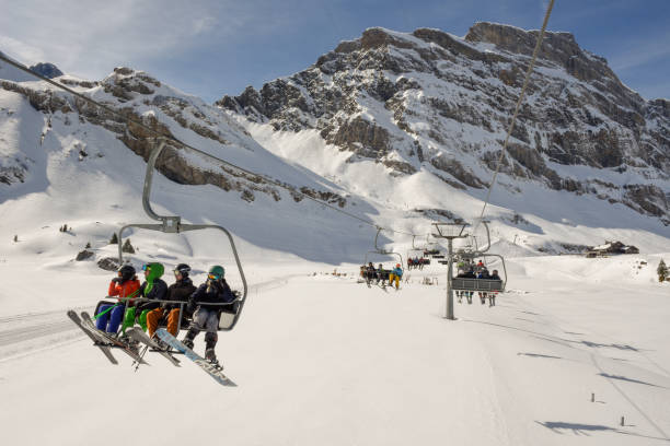 People skiing and going up the mountain by chairlift at Engelberg on the Swiss alps Engelberg, Switzerland - 3 March 2019: People skiing and going up the mountain by chairlift at Engelberg on the Swiss alps engelberg photos stock pictures, royalty-free photos & images