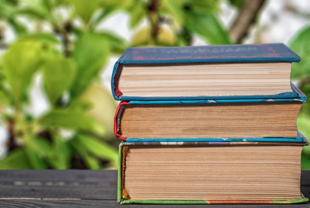 istock books stacked vertically on a desk close up 1139935009