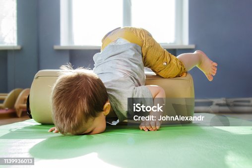 istock the kid fell face down on the rug during a session with a roller 1139936013