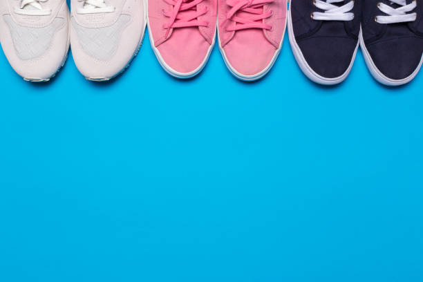 istock colorful  shoes top view. Set of different sneakers on blue background, copy space. Team game, seasonal discount concept 1139940708