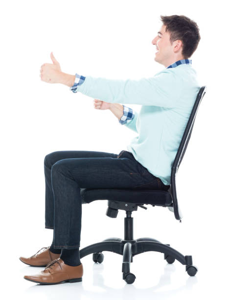 istock Handsome young man sitting and being cheerful, side view. 1139941114