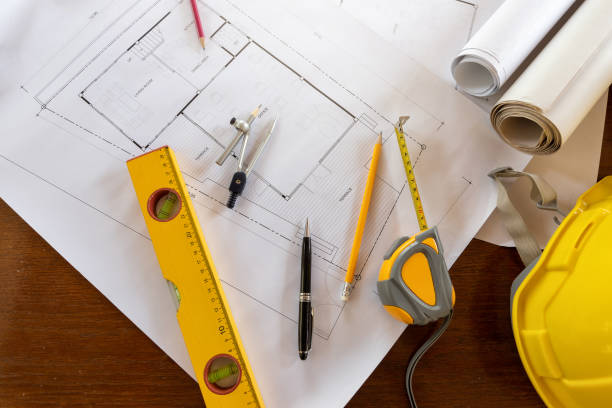 istock Top view of measurement tool with helmet on blueprint, architectural concept 1139941225