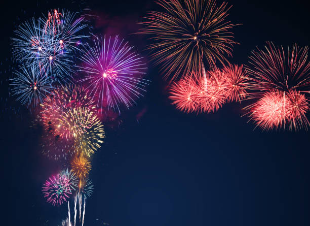 istock colorful fireworks on the black sky background with free space for text. Celebration and anniversary concept 1139942937