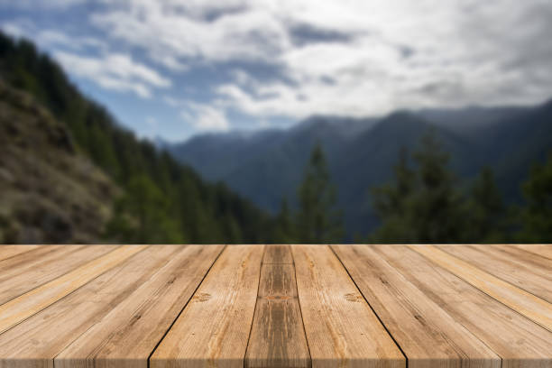 istock Empty wooden desk of free space and spring time with blurred background. 1139944575