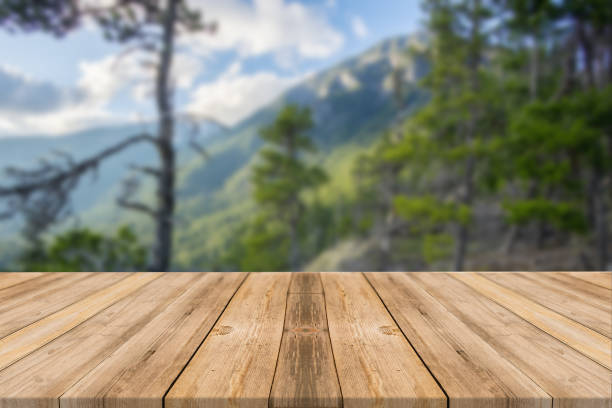 istock Empty wooden desk of free space and spring time with blurred background. 1139944675