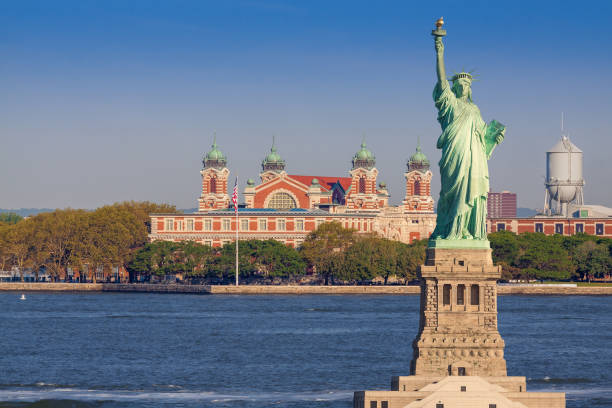 Statue of Liberty, Ellis Island and Water of New York Harbor, NY, USA. stock photo