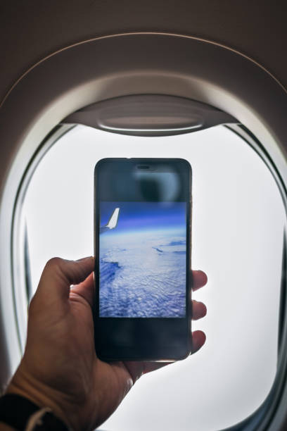 istock Traveler Taking Pictures Using Phone From Airplane 1139946763