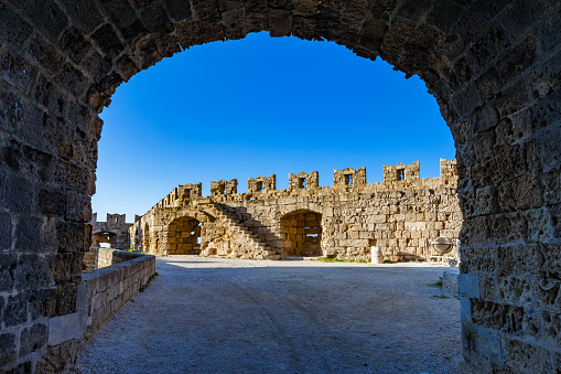 Fort walls and arch in the Palace of the Grand Master of the Knights of Rhodes, Greece on a sunny day.