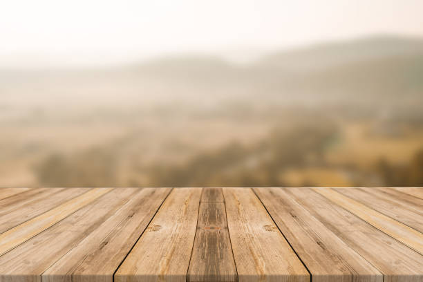 istock Empty wooden desk of free space and spring time with blurred background. 1139947974