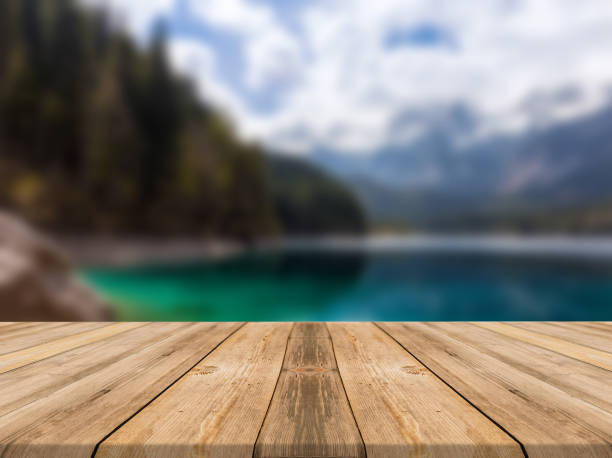 istock Empty wooden desk of free space and spring time with blurred background. 1139948060