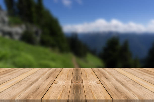 istock Empty wooden desk of free space and spring time with blurred background. 1139948202