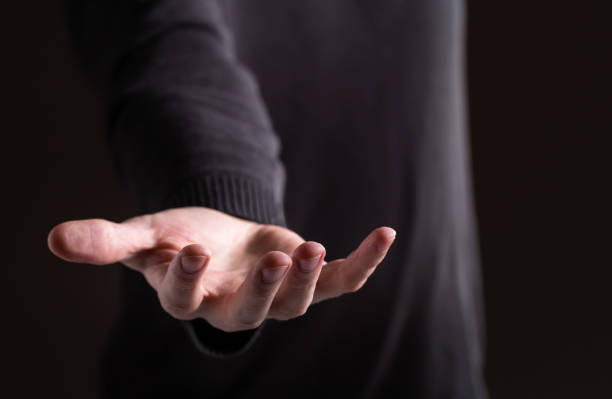 istock Man holding his hand and showing something 1139948409