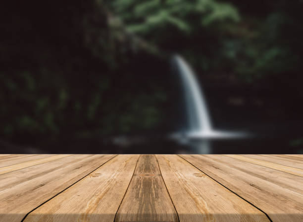 istock Empty wooden desk of free space and spring time with blurred background. 1139948599