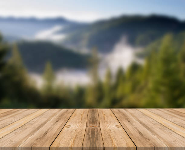 istock Empty wooden desk of free space and spring time with blurred background. 1139948624